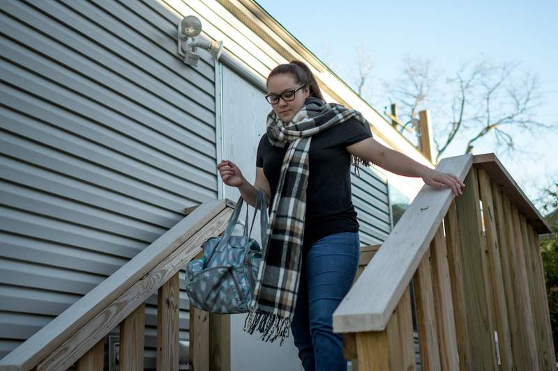 woman walks down stairs of manufactured home