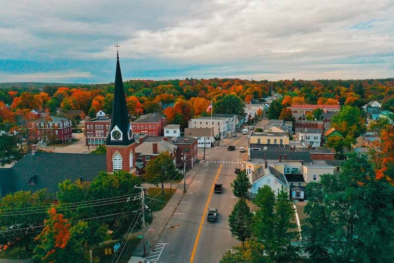  Downtown Farmington, New Hampshire with vibrant fall colors on the trees in the background.