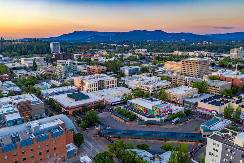 Downtown Eugene Oregon at sunset with mountains in the background.