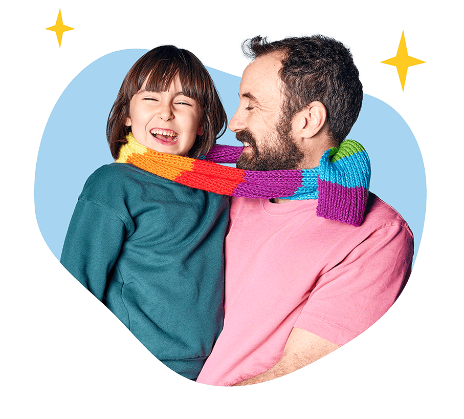 Smiling father holding his laughing child with a colorful striped scarf looped around their necks, surrounded by illustrated sparkles.