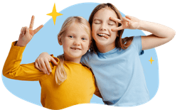 two girls smiling, holding up two fingers in a peace symbol