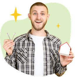 Smiling man holding keys and a small home.