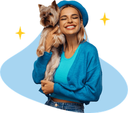 woman holding her dog in her home