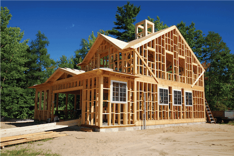 Wooden house frame under construction.