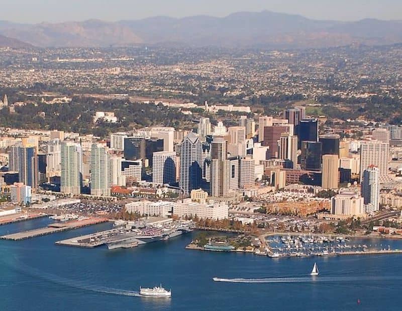 San Diego view from water featuring high rises along the coast and boats in the water.