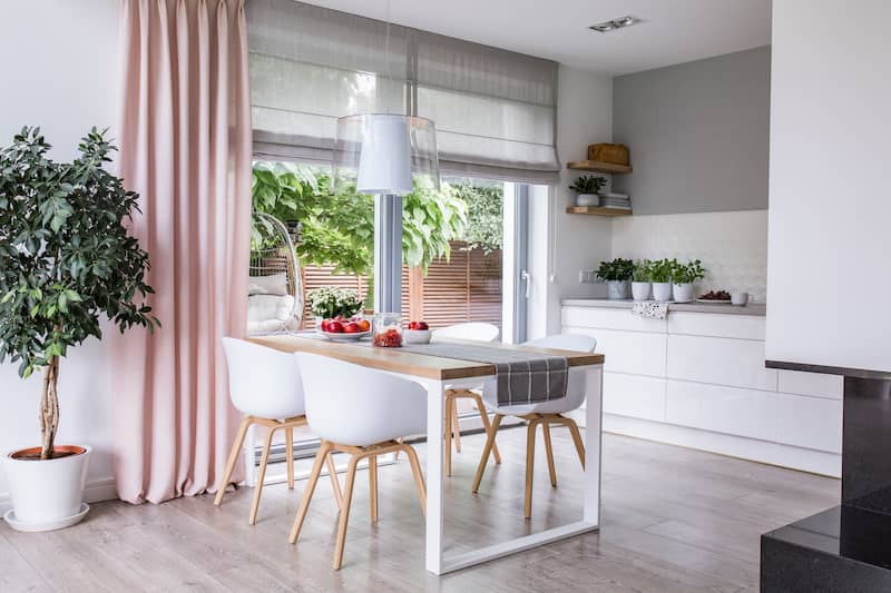 Kitchen with dusty rose drapes pulled open to patio.