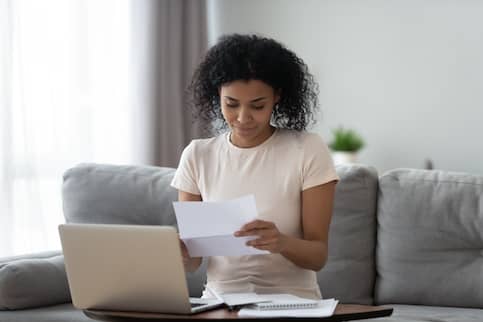 African-American woman reviews paperwork.