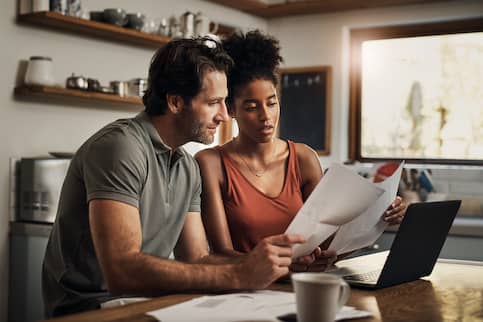 Couple go over paperwork together.