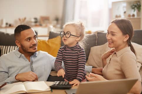 Couple with toddler who is wearing mother's glasses.