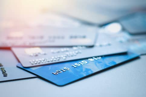 A couple of credit or debit cards spread out on a flat surface.