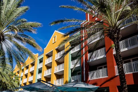 Colorful condos flanked by palm trees.