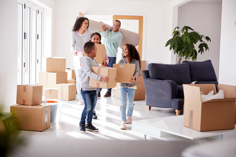 Happy family with kids moving into new home.