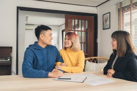 Happy Young Asian Couple And Realtor Agent.