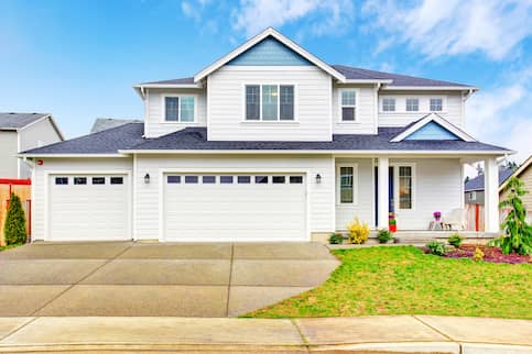 White two story house with two garages.