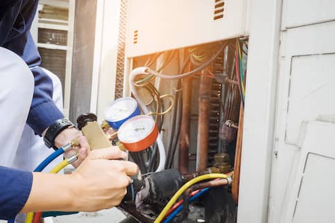 Man checking air conditioner.