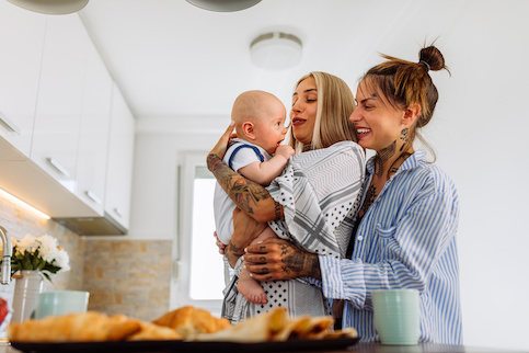 Happy mothers with baby in new home.