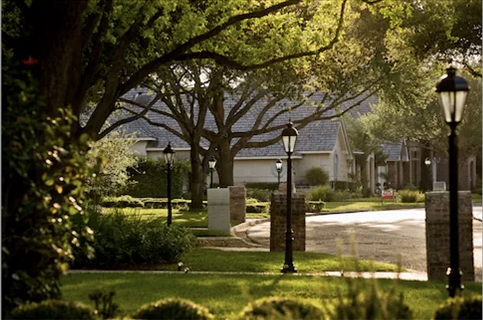 Neighborhood with trees and lamp-posts.