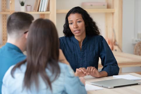 Real estate agent speaks with potential buyers.