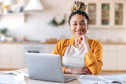 Real estate broker woman using laptop at desk.