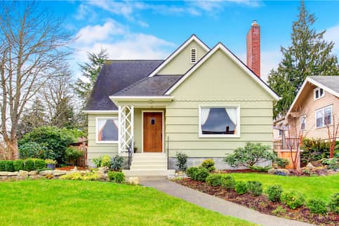 A small American house with well kept lawn.