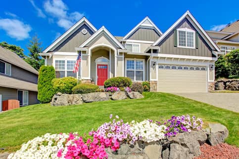 Sunny home with garden and American flag.