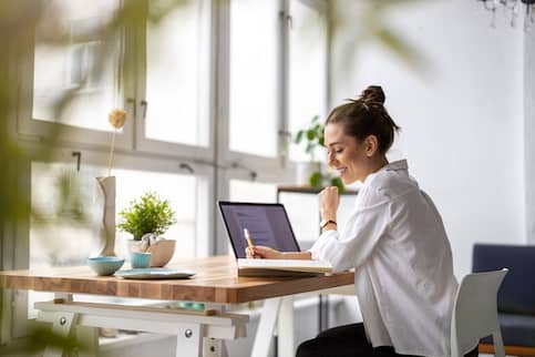 Woman at desk with laptop.