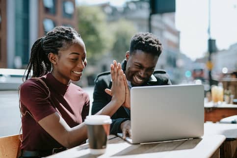 Young African-American couple high-five.