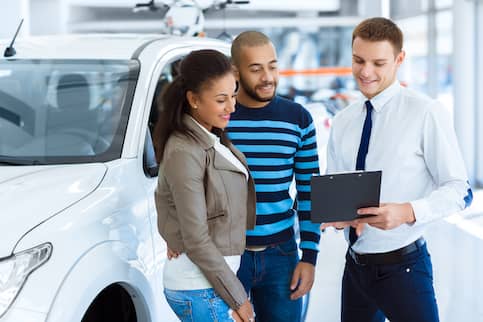 Young couple at dealership.