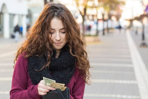 Young Shopper Woman Taking Out Money From Wallet On Street