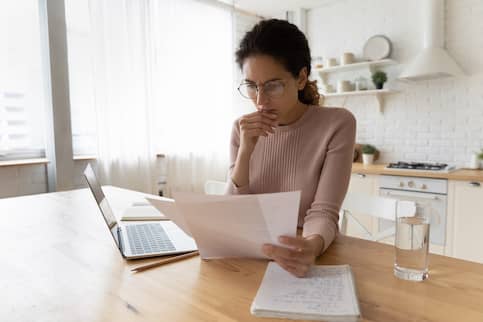 Young woman studying paperwork.