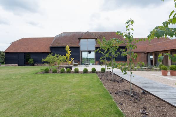 Converted large single story barn with landscaping.