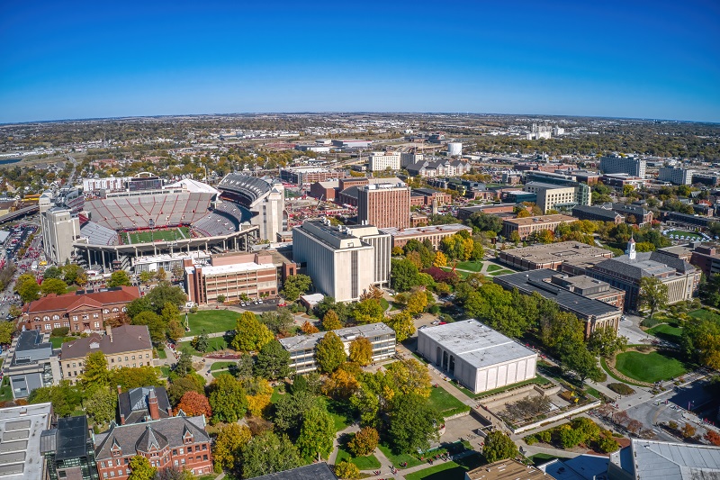 Downtown Lincoln with buildings, trees and football stadium.