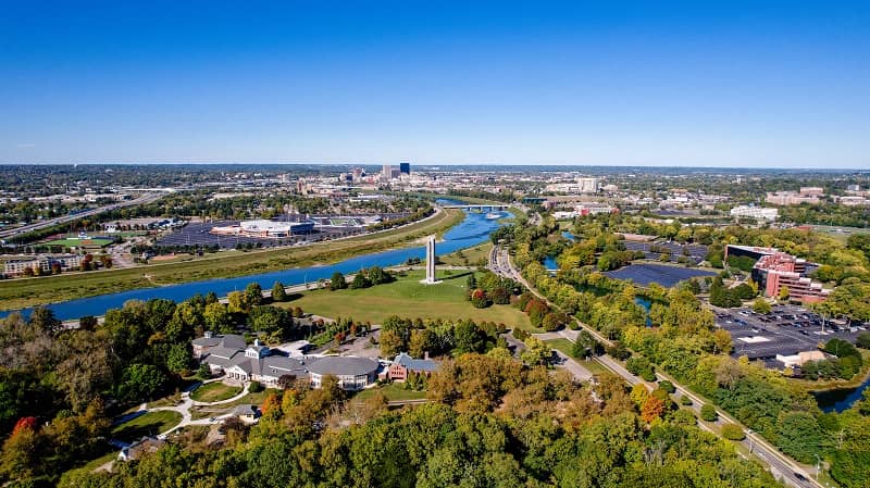 Arial view of Dayton with river, trees, buildings and Witches Tower.