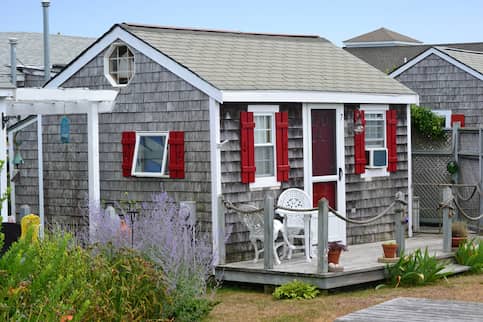 Grey shingled New England style small cottage.