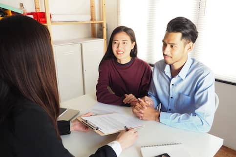 Agent discussing with customers about information on her new property