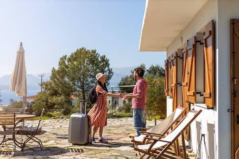 An Airbnb host greeting their guest.