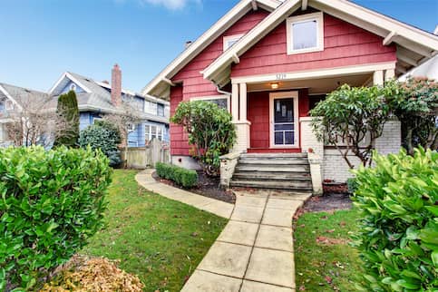 Classic craftsman American house, painted red with white trim.