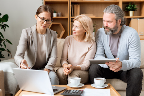 Couple meeting with real estate agent to finalize closing.