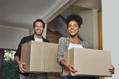 Inter-racial couple moving into new home.