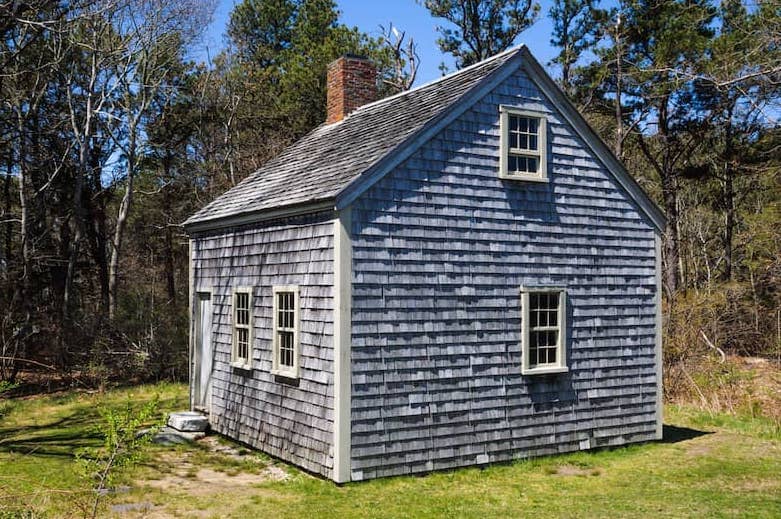 Small grey shingled half cape cod starter historic home, the Harris-Black house, dated back to 1795 is possibly the last remaining primitive one room house on Cape Cod, Brewster, Massachusetts.