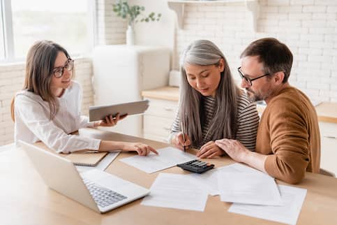 Insurance agent with older couple in their home.