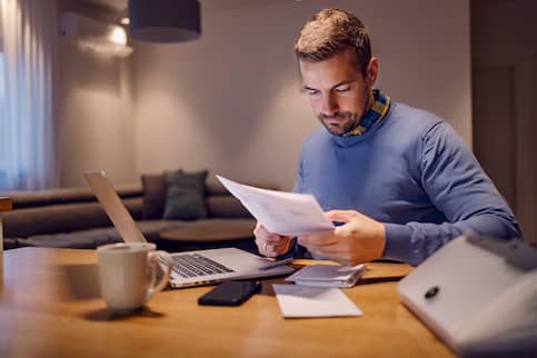 Man looking over bills.