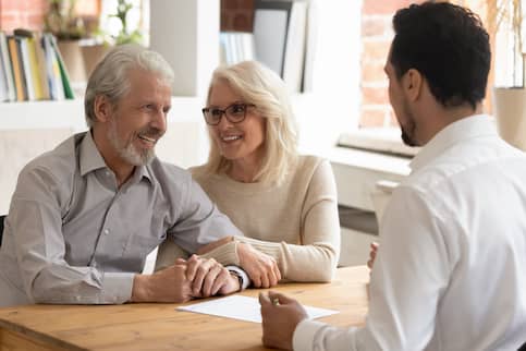 Older couple meeting and talking with a businessman.