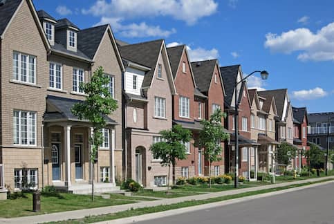 Row of modern townhouses in springtime.