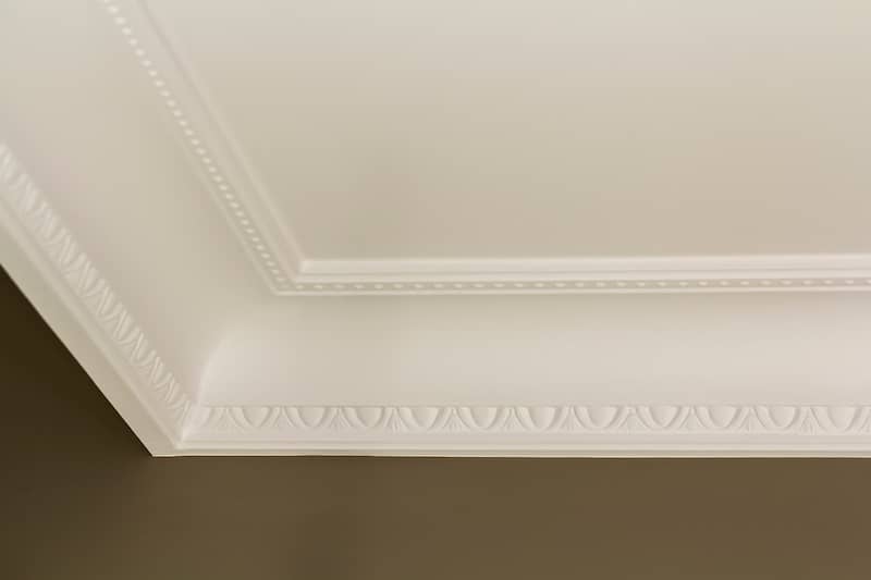 Detailed view of the trim on a coved ceiling corner.