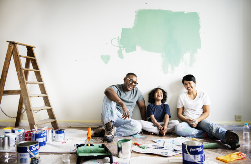 Family resting after painting a wall