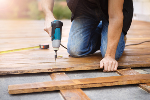 Man installing wood flooring.