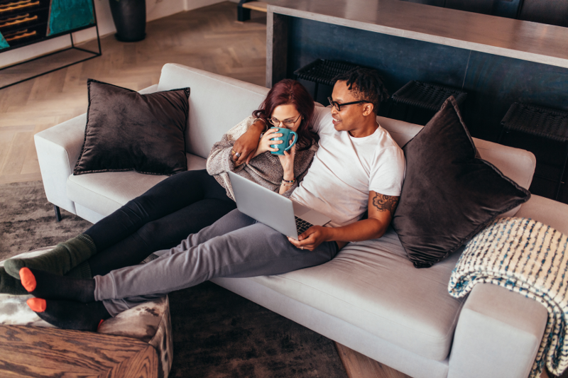 Couple relaxing on couch together.