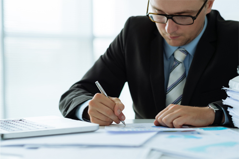 Man in suit signing hiring documents