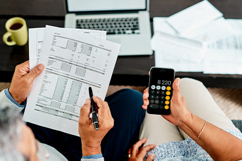 Aerial view of a couple reviewing their real estate taxes during tax season.